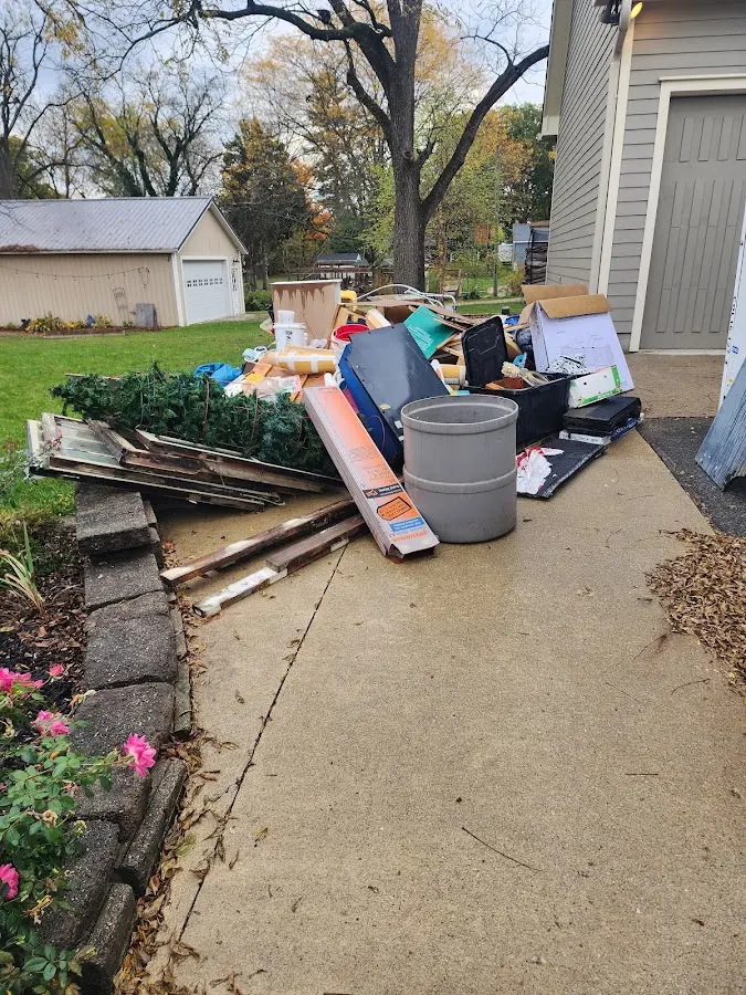 Dumpster being loaded with debris for 10 Yard Dumpster Rental in Lindsborg